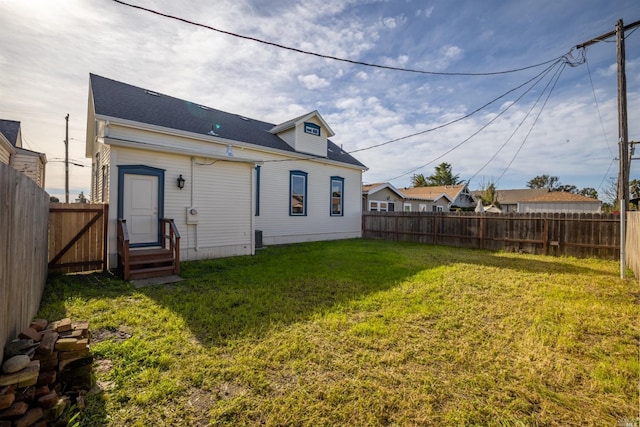 back of property featuring a yard