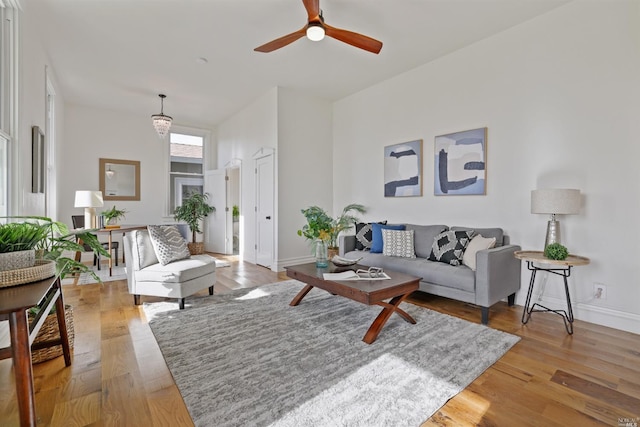 living room featuring light wood-type flooring and ceiling fan