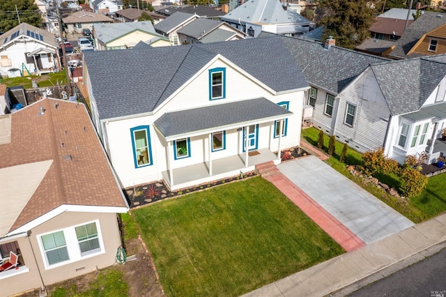 view of front of house with covered porch and a front yard