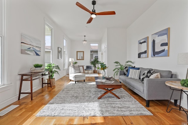 living room with hardwood / wood-style flooring and ceiling fan