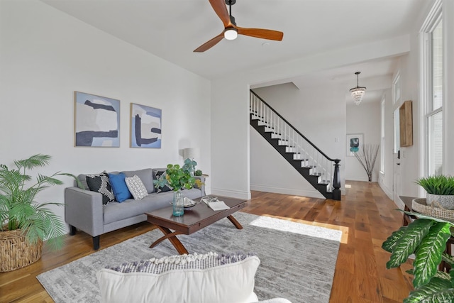 living room featuring ceiling fan and hardwood / wood-style flooring