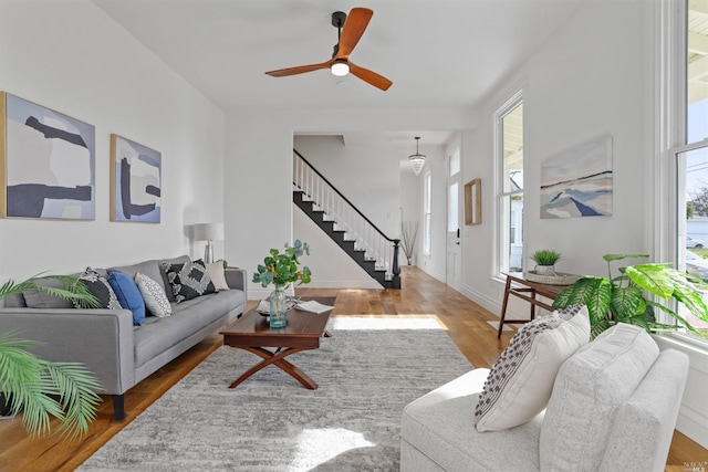 living room with hardwood / wood-style floors and ceiling fan