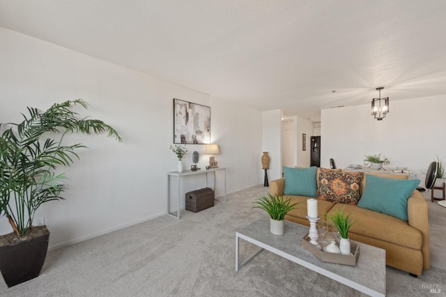 living room featuring an inviting chandelier and light colored carpet