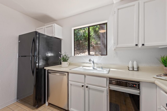 kitchen with sink, white cabinetry, black fridge, and stainless steel dishwasher