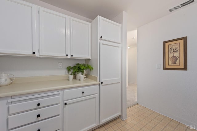 kitchen featuring white cabinets