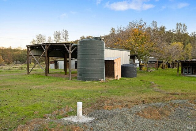 view of outbuilding featuring a yard