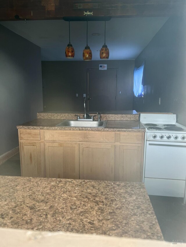 kitchen featuring sink, white range oven, tile patterned flooring, and light brown cabinets