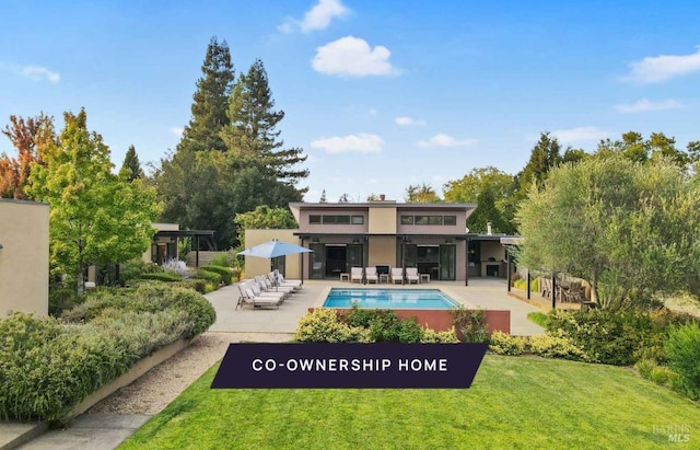 back of house featuring a patio and a lawn