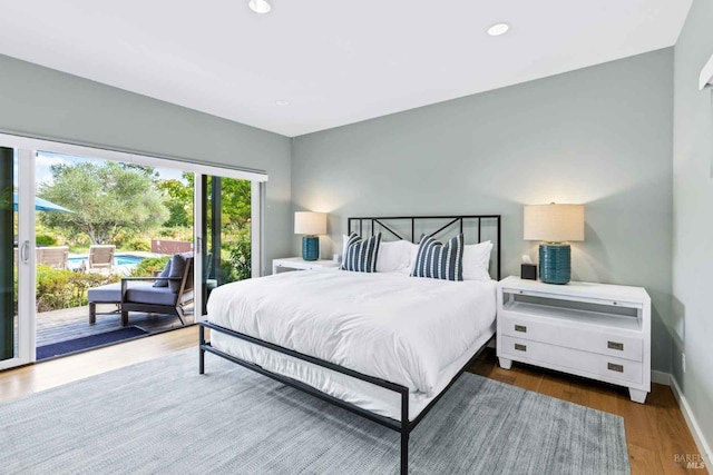 bedroom featuring access to exterior and wood-type flooring