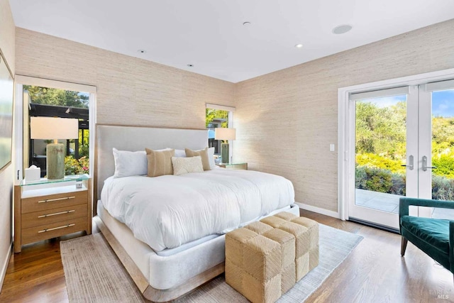 bedroom with hardwood / wood-style flooring, french doors, and access to exterior