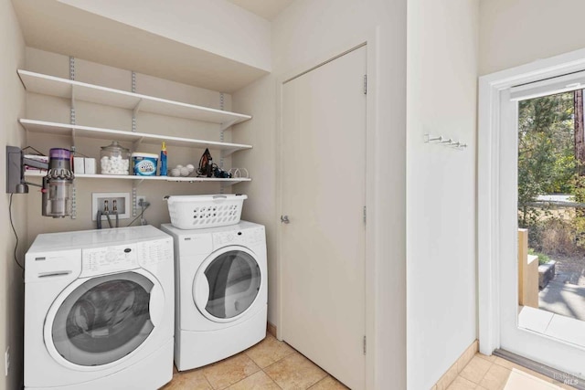 laundry area with light tile patterned floors and washer and dryer