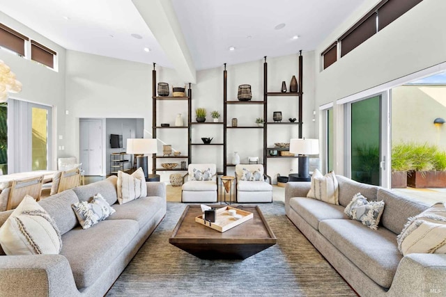 living room featuring high vaulted ceiling