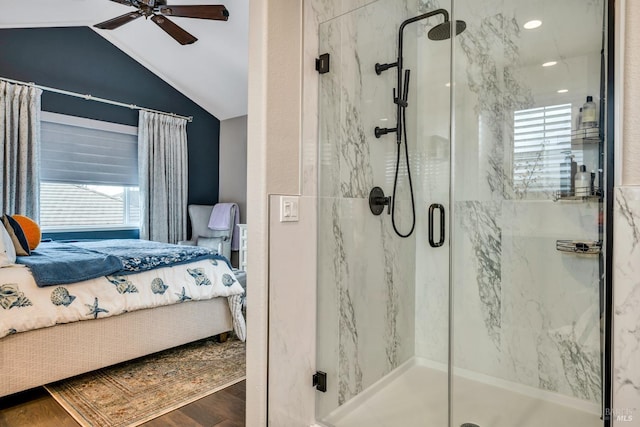 bathroom with a shower with shower door, ceiling fan, wood-type flooring, and vaulted ceiling