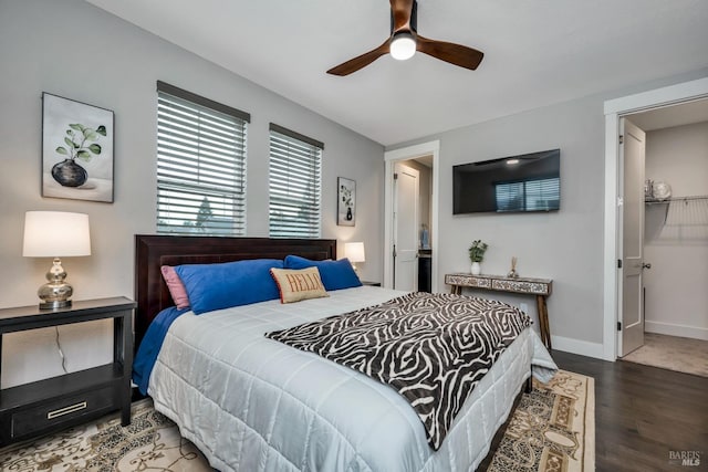 bedroom with ensuite bath, ceiling fan, and hardwood / wood-style flooring