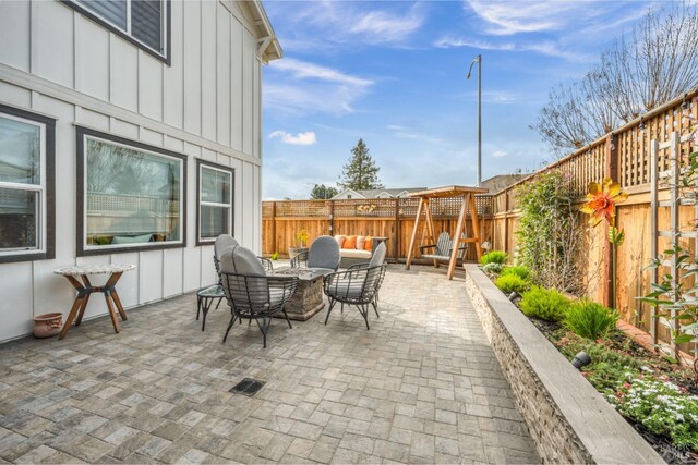 view of patio featuring an outdoor living space with a fire pit