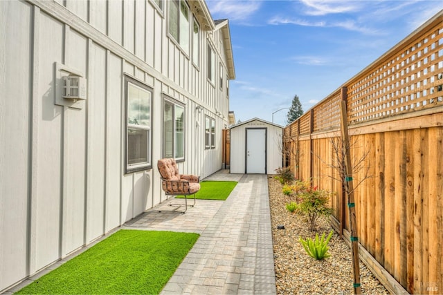 view of yard with a storage shed and a patio