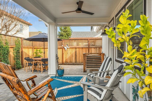 view of patio featuring ceiling fan