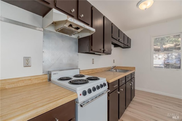 kitchen with electric stove, sink, dark brown cabinetry, and light hardwood / wood-style flooring