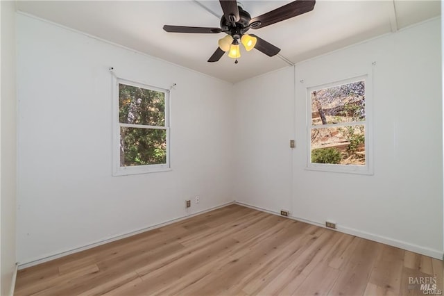 spare room with light wood-type flooring and ceiling fan