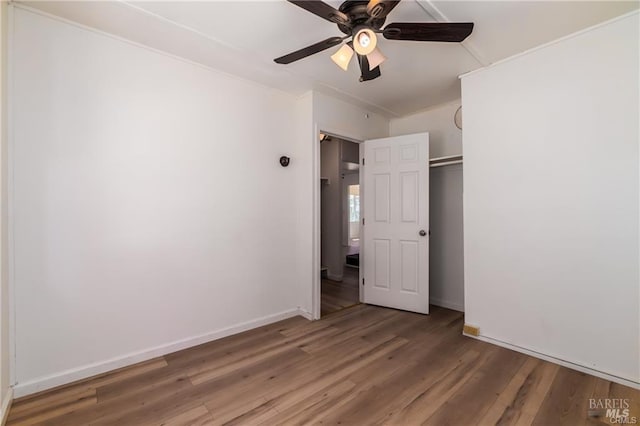 empty room with wood-type flooring and ceiling fan