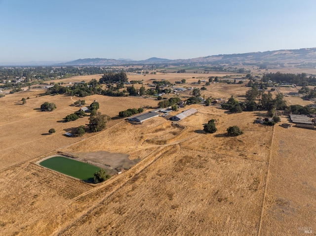 drone / aerial view with a mountain view and a rural view