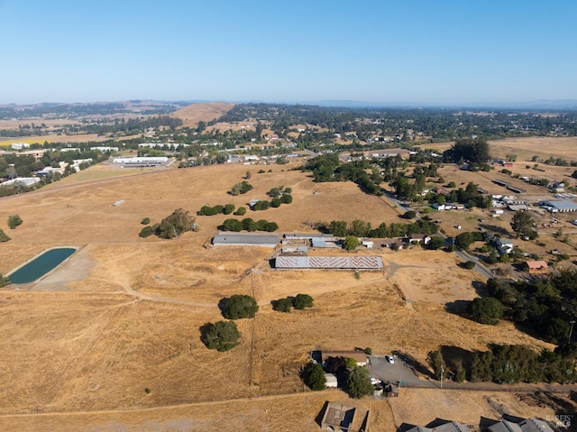 birds eye view of property with a rural view