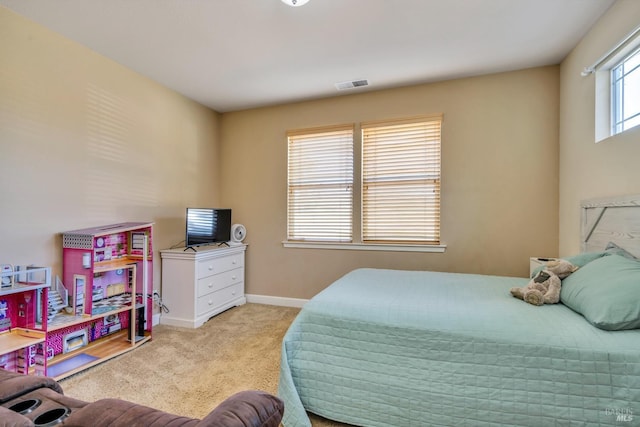 bedroom with light colored carpet