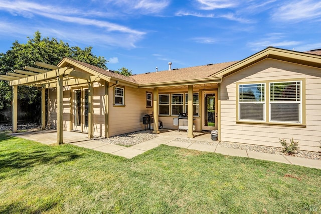 back of property featuring a pergola, a patio, and a yard