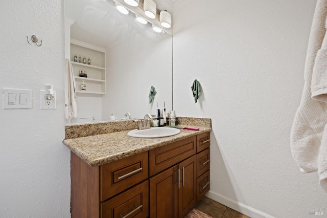 bathroom featuring baseboards and vanity