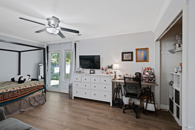 bedroom with a ceiling fan, dark wood-style flooring, crown molding, and access to exterior