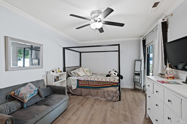 bedroom with visible vents, baseboards, ornamental molding, light wood-style flooring, and a ceiling fan