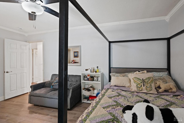 bedroom with ceiling fan, wood finished floors, and crown molding