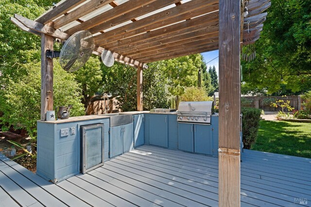 wooden terrace featuring area for grilling, a grill, and a pergola