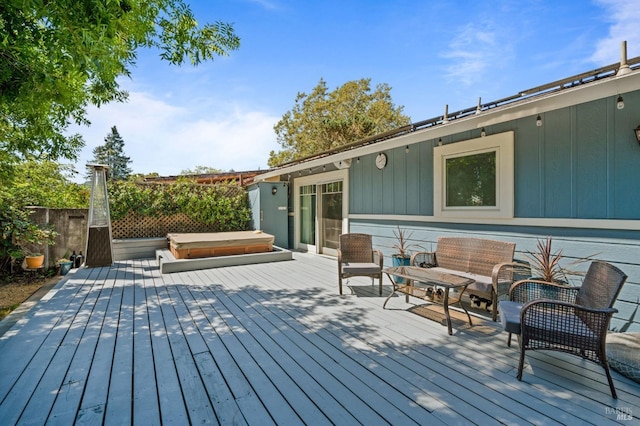 deck with a covered hot tub