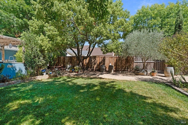 view of yard featuring a pergola and fence