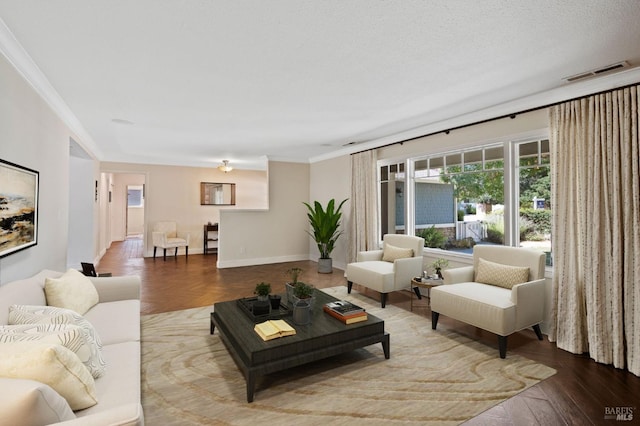 living room with visible vents, baseboards, a textured ceiling, and crown molding