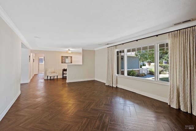 empty room with baseboards, visible vents, and a textured ceiling