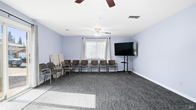 living room with carpet floors and ceiling fan