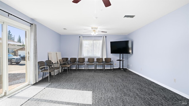 sitting room featuring carpet floors, ceiling fan, and baseboards