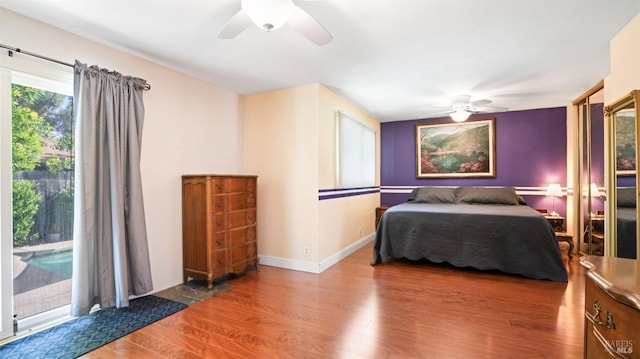 bedroom with ceiling fan, baseboards, wood finished floors, and access to exterior