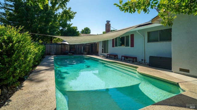 view of pool featuring a fenced backyard, a fenced in pool, and a patio