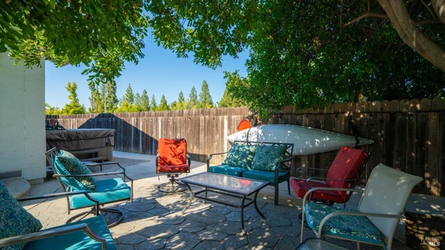 view of patio / terrace with a hot tub and outdoor lounge area