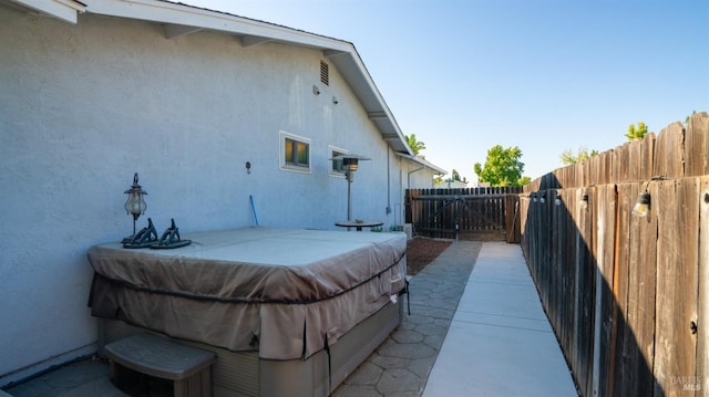 exterior space with fence, a patio, and stucco siding