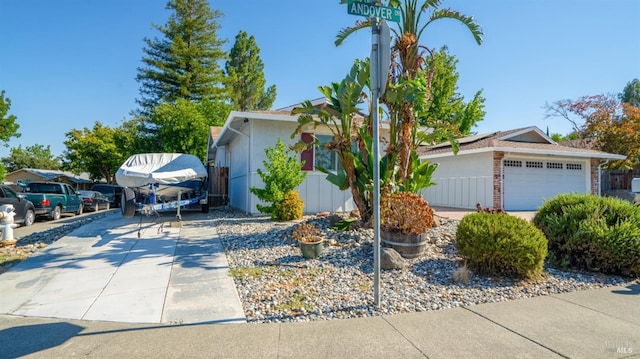 single story home featuring concrete driveway and brick siding