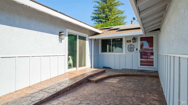 entrance to property with solar panels and board and batten siding