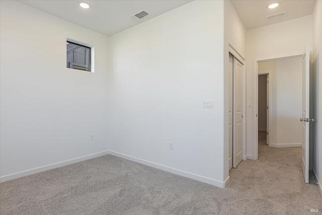 unfurnished room with light carpet