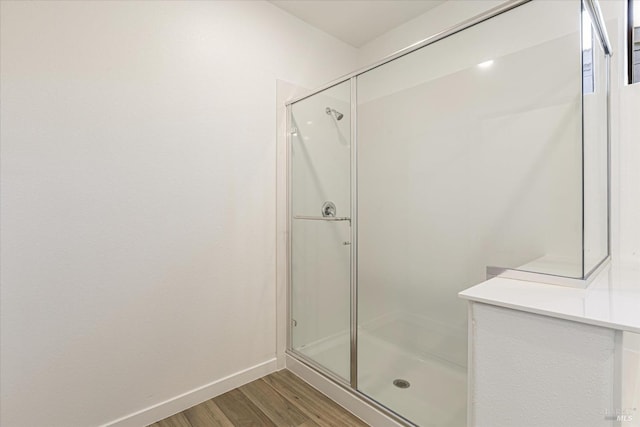 bathroom featuring walk in shower and hardwood / wood-style flooring