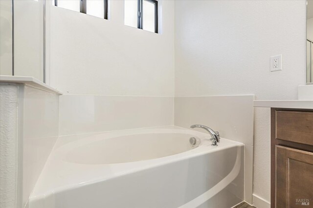 bathroom with a bath and vanity