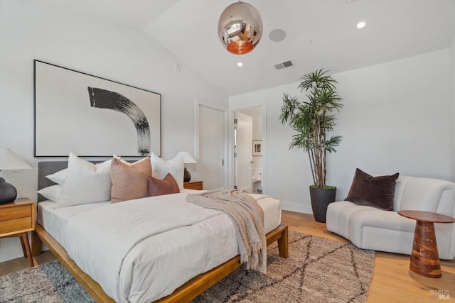 bedroom with lofted ceiling, visible vents, wood finished floors, and recessed lighting