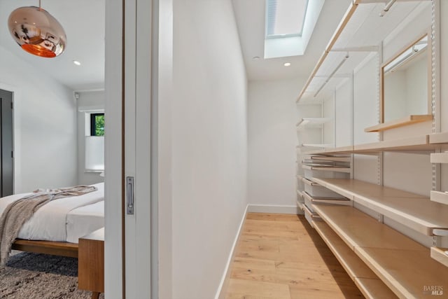 interior space with a skylight and wood finished floors